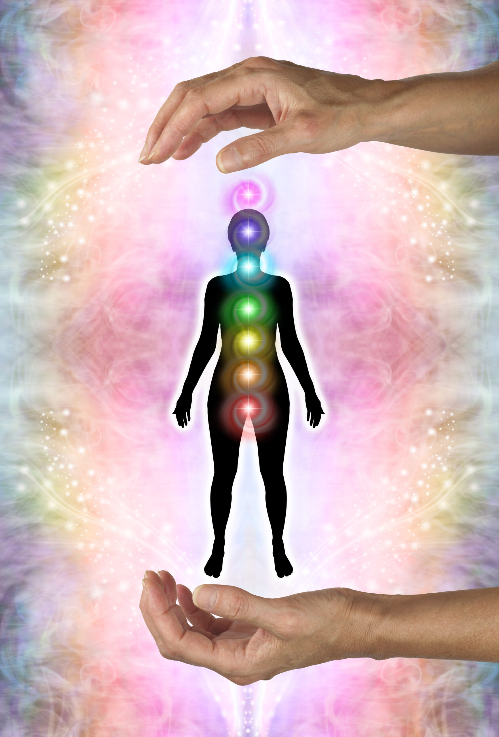 diagram of distant healing with hands above and below a female silhouette against an energy field background and the seven chakras